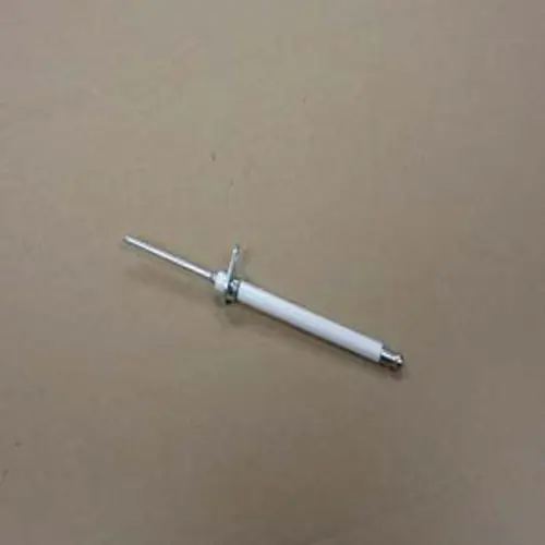Ionisationselektrode von Remeha, bestehend aus einem weißen Körper mit einem Metallstab, auf einer neutralen Oberfläche liegend.